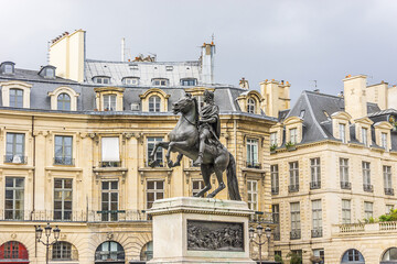 Fototapeta na wymiar Victory Square (Place des Victoires) is a circular place in Paris, located northeast from Palais Royal. At center of Victory Square is equestrian monument of King Louis XIV (1828). Paris, France.