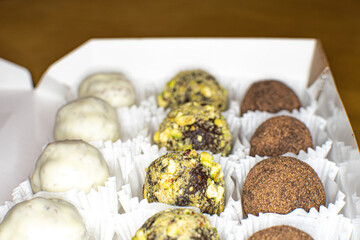 different round candies with chocolate, nuts and coconut