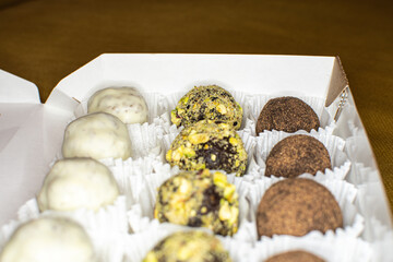 different round candies with chocolate, nuts and coconut