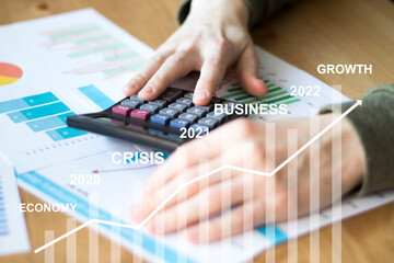 Businessman leads calculation of profits and makes the forecast of economic growth in the coming...