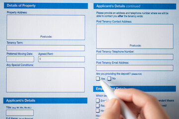 Woman customer filling property reservation form, tick yes and agrees to leave a deposit. Rental agreement apartment, house. Close up. Selective focus.