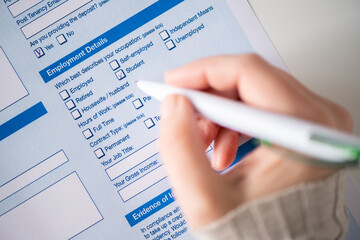 Woman filling employment contract, tick student in count employment detail. Close up. Selective focus.