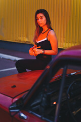 Naklejka premium Beautiful young girl posing with vintage red old car.