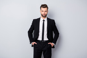 Obraz na płótnie Canvas Portrait of handsome modern man entrepreneur ready to deal contracts with partners put hands pockets wear classy outfit isolated over grey color background