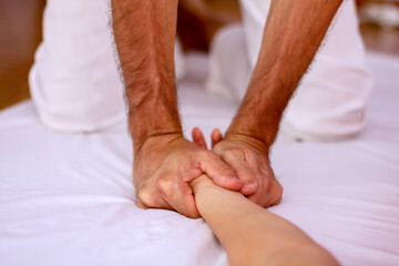 Fototapeta na wymiar Shiatsu massage supine position massaging palm stretching opening palms.