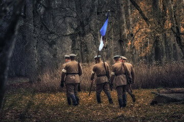 Estonian soldiers with flag in the forest. 1918 year