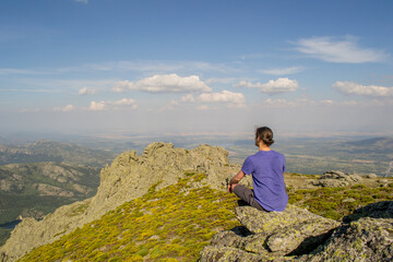 a young man does mindfulness on the mountain