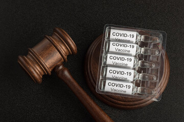 Judge gavel and ampoules with letters covid19. Laws against coronavirus covid-19