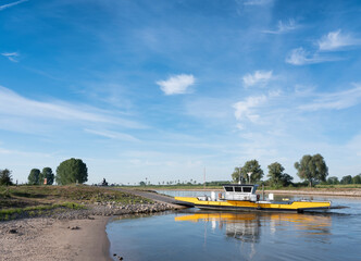yellow ferry on river ijssel between olburgen and dieren in gelderland