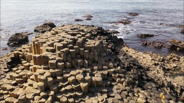 Drone wrap around the famous fifty million year old basalt rock formations at the Giants Causeway in N. Ireland