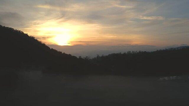 aerial view sunrise in the mountain with foging forest