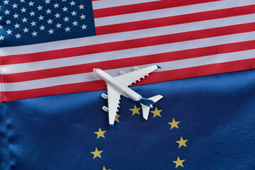Flag of European Union and USA with toy airplane. Concept of flights from Europe to United States...