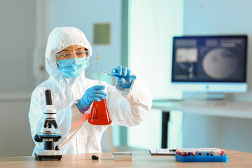 Scientist working with sample in laboratory