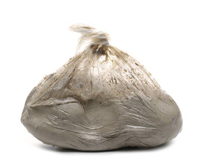 Grey modelling clay in plastic bag isolated on white background