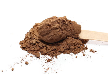Cocoa powder pile with wooden spoon isolated on white background