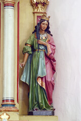 Fototapeta na wymiar St. Catherine of Alexandria, statue on the altar of St. Barbara in the parish church of the Assumption of the Virgin Mary in Pescenica, Croatia