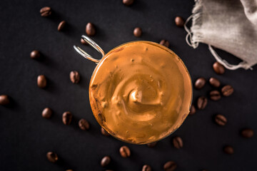 Creamy iced dalgona coffee on black background. Top view	

