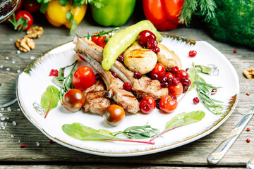 Restaurant dish on a wooden background. Azerbaijani shish kebab and grilled ribs.