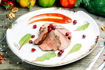 Restaurant dish on a wooden background. Azerbaijani shish kebab and grilled ribs.