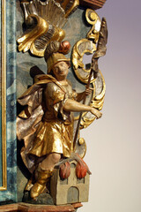 Fototapeta na wymiar Saint Florian statue on a high altar at Holy Spirit Chapel in Lucelnica, Croatia
