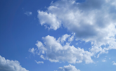 Naklejka na ściany i meble Beautiful bright blue sky and white fluffy clouds