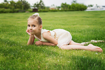 happy little girl on the beach. little girl in a white dress. little girl lying on the grass. little girl walking on the road