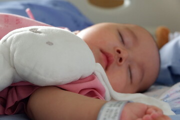 The sick boy was sleeping in a hospital bed. Boy is sick with Respiratory Syncytial Virus.