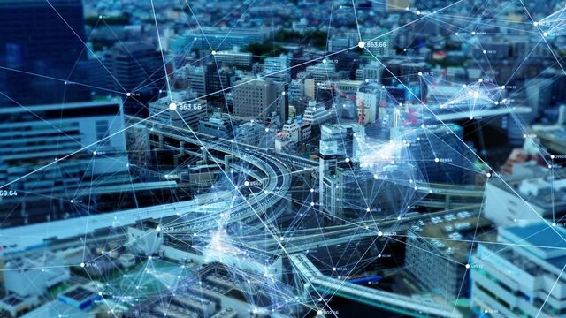 都市とネットワーク　近代的なビル群空撮と通信イメージ　IoT　ICT