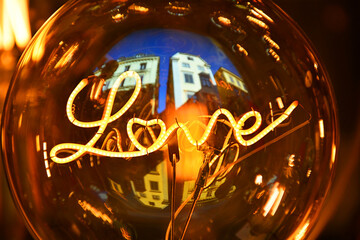 Close-up of the filament in the form of the word "love" in an incandescent light bulb