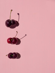 double fused ugly cherries on pink background top view. copy space