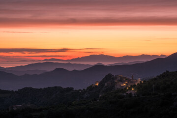 Fototapeta premium Dawn breaking over Speloncato and coastline of Corsica
