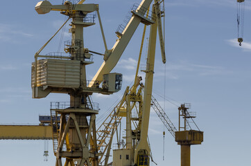 Fototapeta na wymiar SHIPYARD AND SEAPORT - A set of port cranes at the port repair and reloading quays