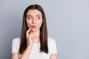 Closeup photo of attractive lady groomed hairdo look interested side empty space listen quarantine news lips pouted finger on chin wear casual white t-shirt isolated grey color background