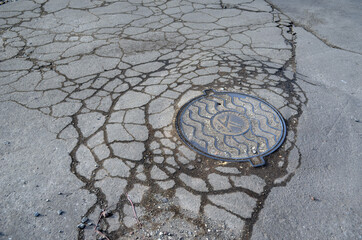 Poor condition of the road surface. Spring season. Hole in the asphalt, risk of movement by car, bad asphalt, dangerous road, potholes in asphalt.  Kiev,Ukraine