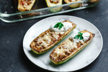 Homemade zucchini stuffed with meat, mushrooms and cheese. Squash boats. Loaded zucchini. Diet menu. Side view, top view.