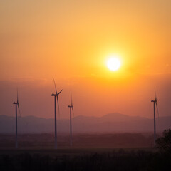 Fototapeta na wymiar Windmill turbine for power generator at sunset