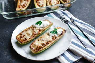 Homemade zucchini stuffed with meat, mushrooms and cheese. Squash boats. Loaded zucchini. Diet menu. Side view, top view.