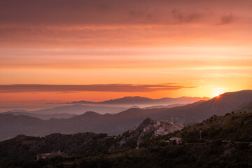 Sunrise over Speloncato and coastline of Corsica