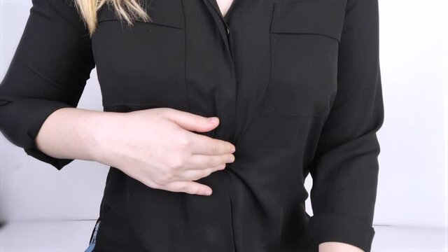 A woman holds on to his stomach. Pain in the abdominal cavity. The concept of diseases of the stomach and digestive system