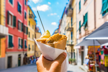 Fritto misto di pesce (Mixed fried fish) with Cinque Terre village background