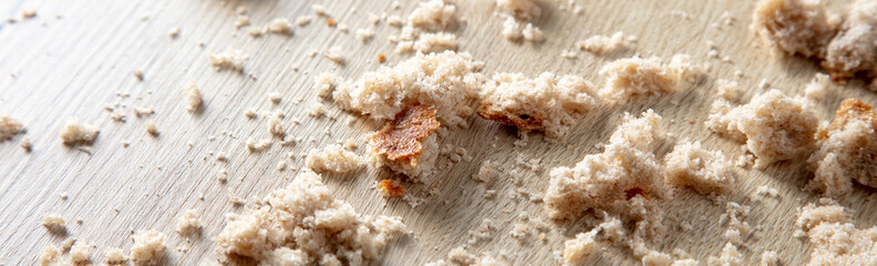Bread crumbs on a wooden table.