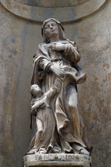 Fototapeta na wymiar Saint Anne with the Virgin Mary, sculpture on the facade of the Franciscan Church of Saint Catherine of Alexandria in Krapina, Croatia