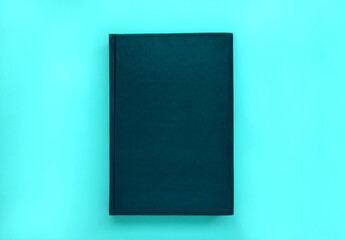 Minimal black leather book cover mock up on blue background.