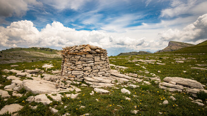 Shepherd's shelter in stone called "borie" located on the High Plateaux of the Vercors in a mineral environment.