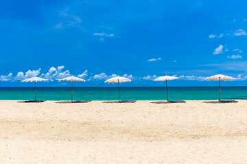 Beach umbrella on beach with blue sky, Phuket Thailand