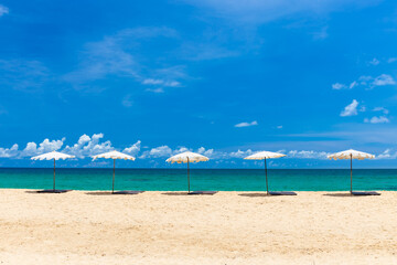 Beach umbrella on beach with blue sky, Phuket Thailand