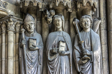 Fototapeta na wymiar Saint-Germain-l'Auxerrois Church situated in Paris, France. Founded in 7 century, church rebuilt many times over several centuries. Sculptures at the entrance to the church.