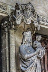 Fototapeta premium Saint-Germain-l'Auxerrois Church situated in Paris, France. Founded in 7 century, church rebuilt many times over several centuries. Sculptures at the entrance to the church.