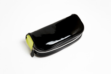 Fototapeta na wymiar Black glossy genuine leather toiletry bag.Cosmetic case. High-resolution photo.