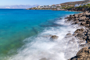 Waves hitting the rocks during hot summer day in Greece